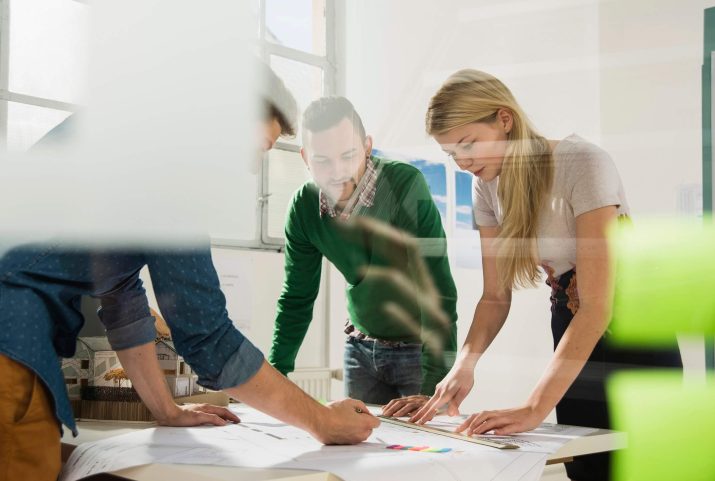 three-young-architects-in-office-discussing-TDD8399